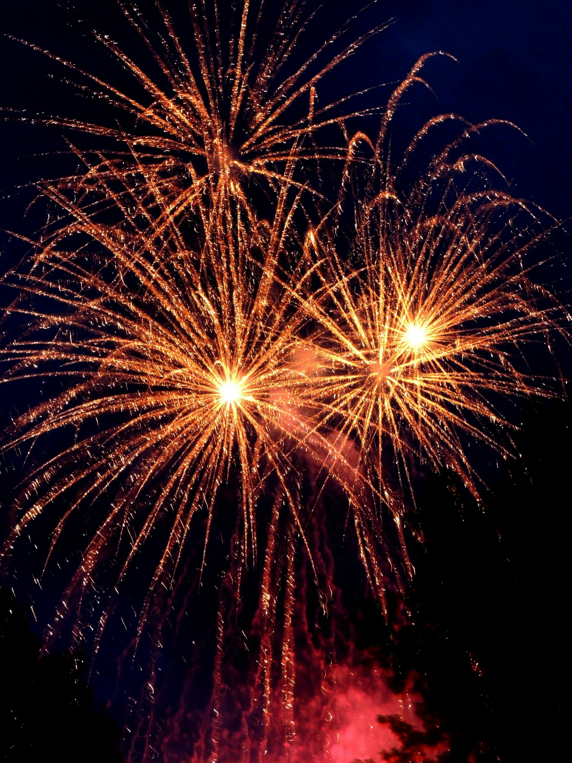 Photo by Sebastian Hietsch Bright and colorful fireworks display lighting up the night sky, perfect for celebrations and festive occasions.