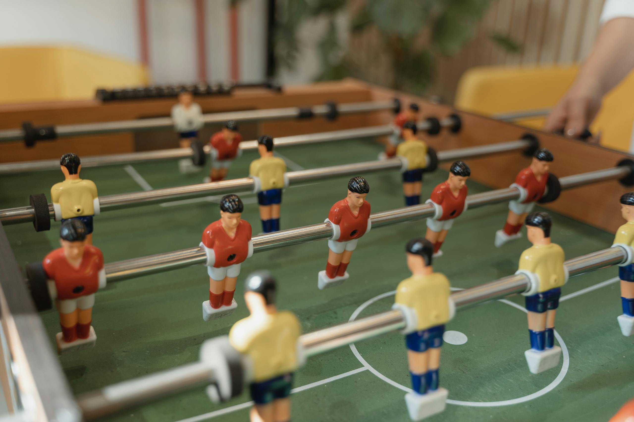 Photo by Tima Miroshnichenko Close-up of a foosball table with colorful players in action, capturing the essence of the game.